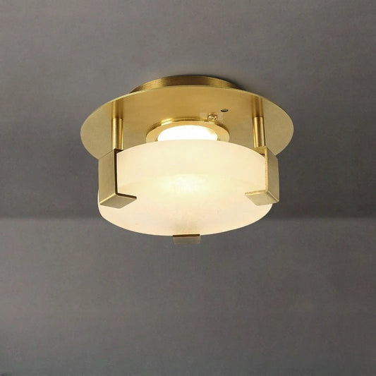 Gold geometric flush mount ceiling light with frosted glass diffuser and crystal accents, viewed from below.
