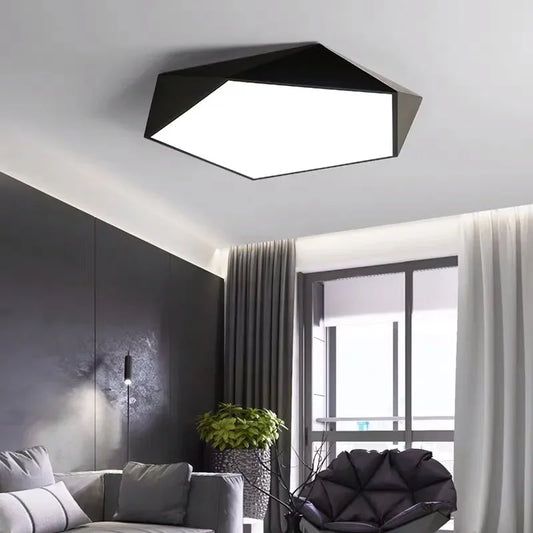 Modern geometric black and white flush mount ceiling light installed in a living room.