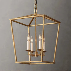 A close-up of a gold geometric cage pendant light with four candle-style bulbs illuminating.