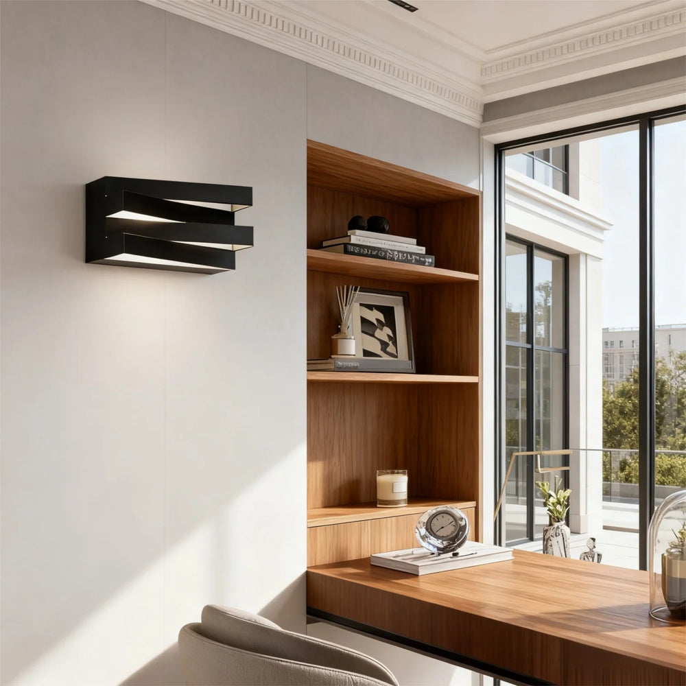 Modern home office with wooden desk, bookshelf, and wall-mounted light fixture.