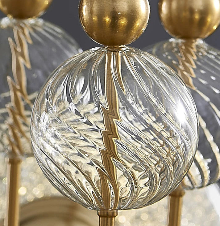 Close-up of a decorative lamp with gold and clear glass elements.