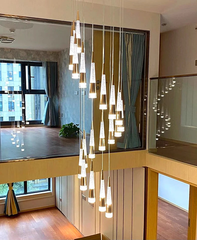 Modern interior with a chandelier hanging between two levels of a home.