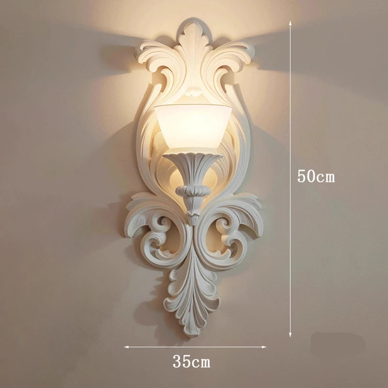Decorative wall lamp with intricate design on a plain wall, featuring dimensions.