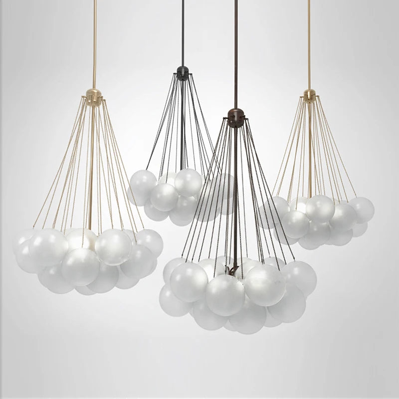 Modern chandelier with white glass balls and metal baskets on a light gray background