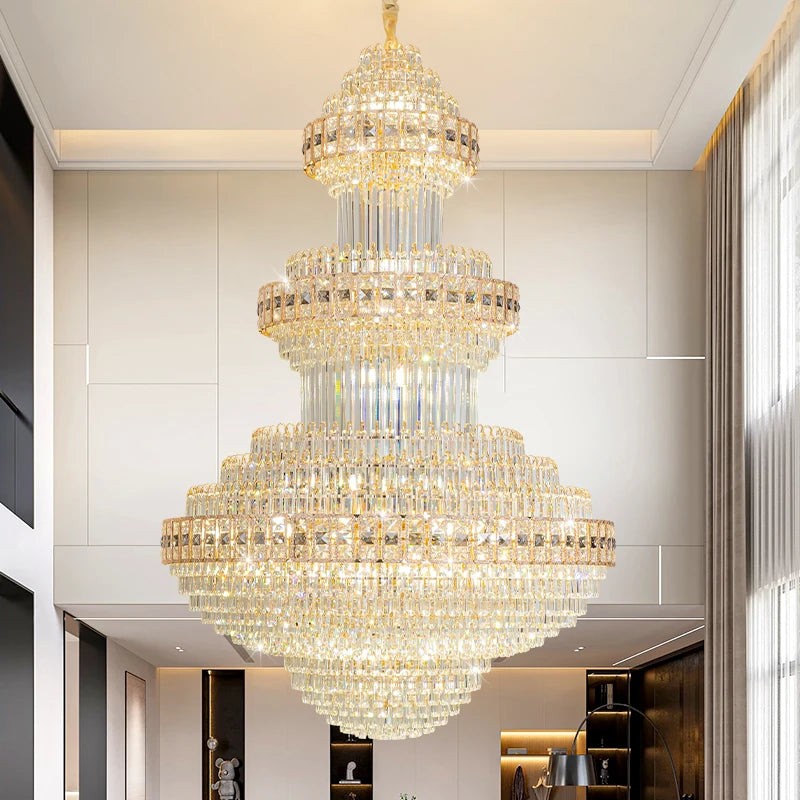 Gold tiered chandelier with cascading crystal droplets, semi-flush mount, in a modern living room.