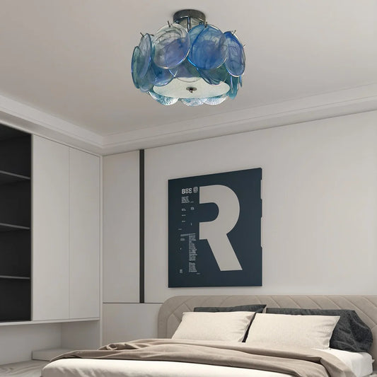 Blue glass floral flush mount ceiling light in a modern bedroom.