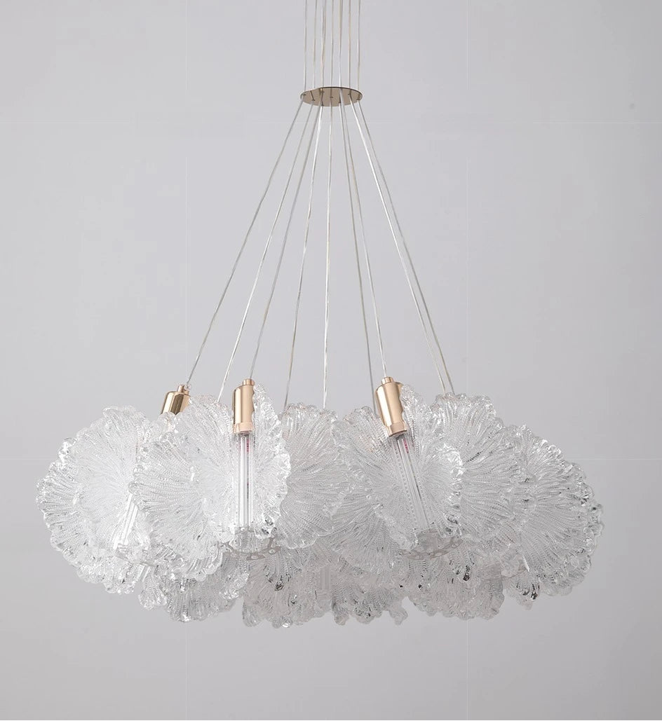 Modern chandelier with glass shades and metallic accents on a gray background