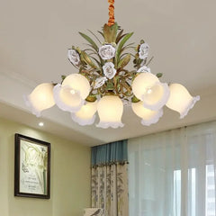 A multi-light gold chandelier with porcelain roses and frosted shades, suspended from a ceiling.