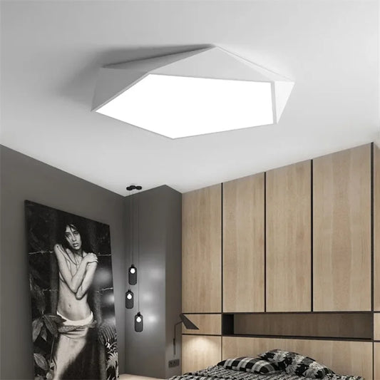 Modern geometric white flush mount ceiling light installed in a bedroom.