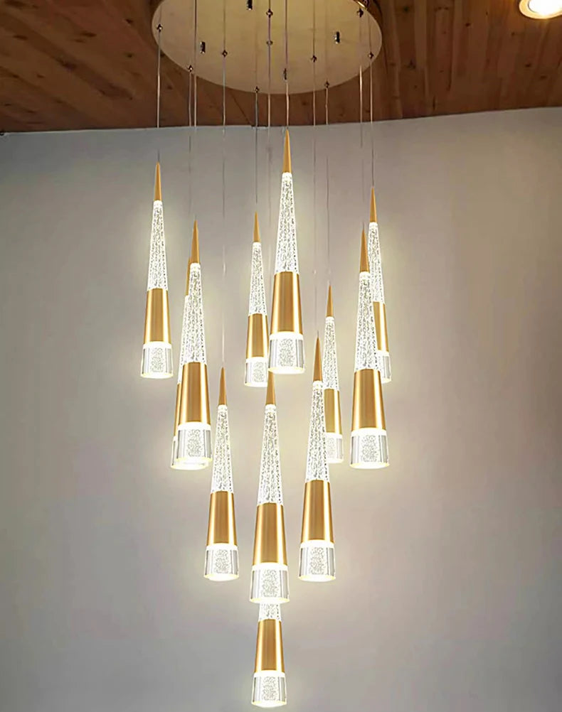 Modern chandelier with multiple cylindrical lights on a plain wall background