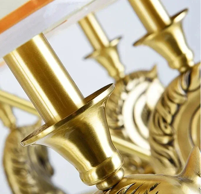 Close-up of a gold decorative item with intricate designs on a white background
