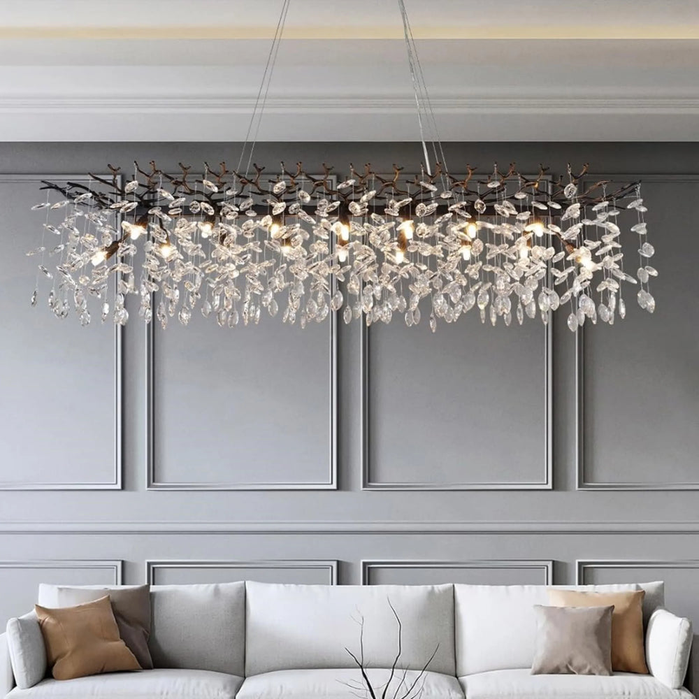 Luxurious chandelier hanging above a sofa in a modern living room.