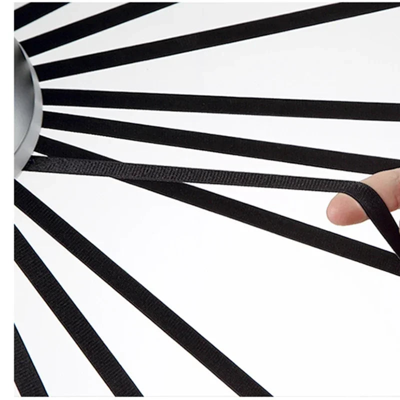 Black and white striped object with a hand holding one end