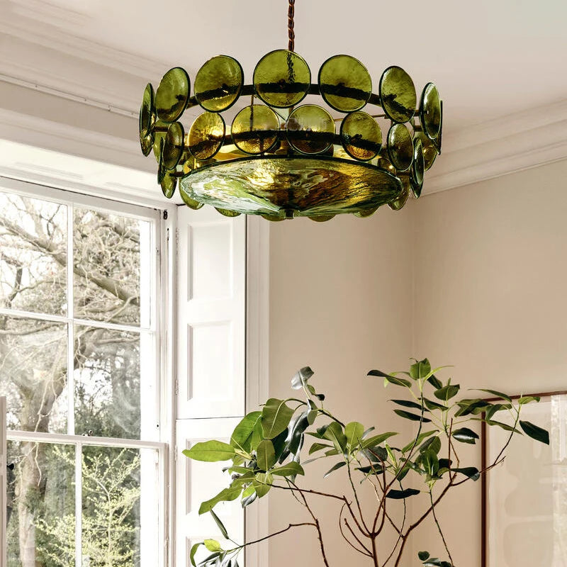 Green glass disc chandelier hanging from a ceiling.