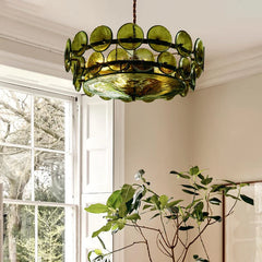 Green glass disc chandelier hanging from a ceiling.