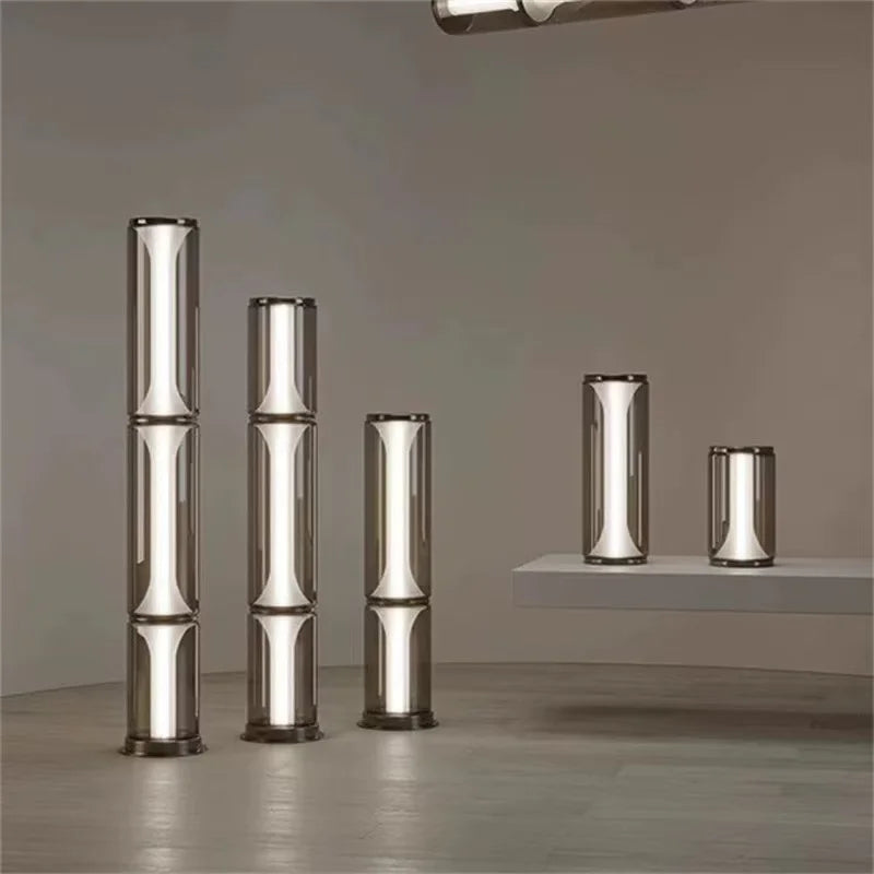 Set of five cylindrical metallic objects on a gray surface with a neutral background