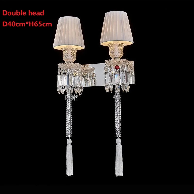 Double-headed wall lamp with crystal details on a black background