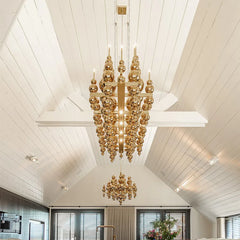 Gold globe cluster pendant light with a tiered, spherical design hanging from a white ceiling.