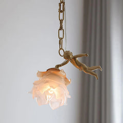 Close-up of a single frosted flower glass shade with a small copper cherub figure reaching towards it, suspended by a chain.