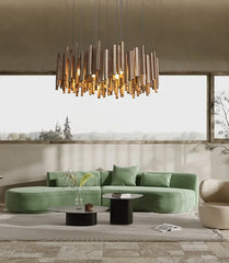 Wooden stick chandelier with neutral lighting in a modern living room with a green sofa