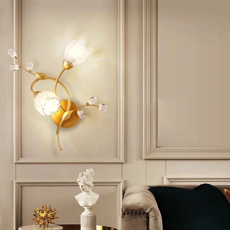 Side view of a gold floral leaf wall sconce, showcasing its curved stem and leaf design.