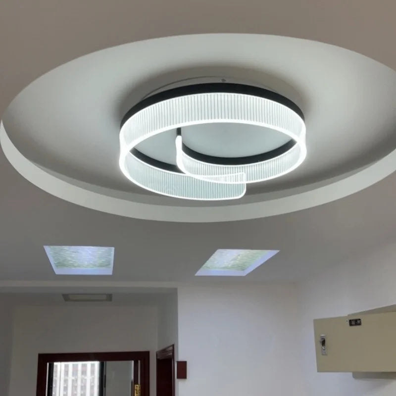 A modern double ring ceiling light installed in a room, showcasing its ambient glow.