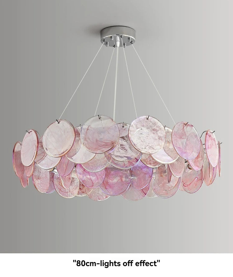 Chandelier with pink circular plates on a gray background
