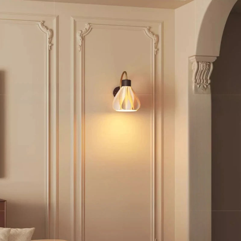 Wall-mounted light fixture on a decorative wall with soft lighting