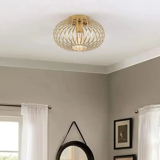 Gold open cage semi-flush ceiling light with a geometric pattern.