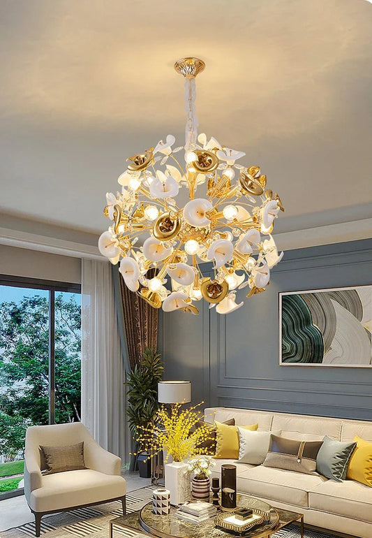 Gold floral chandelier with ceramic petals hanging in a living room