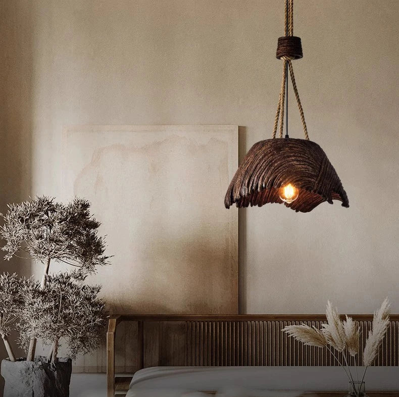 Rustic pendant light hanging in a bedroom with neutral walls and decor.
