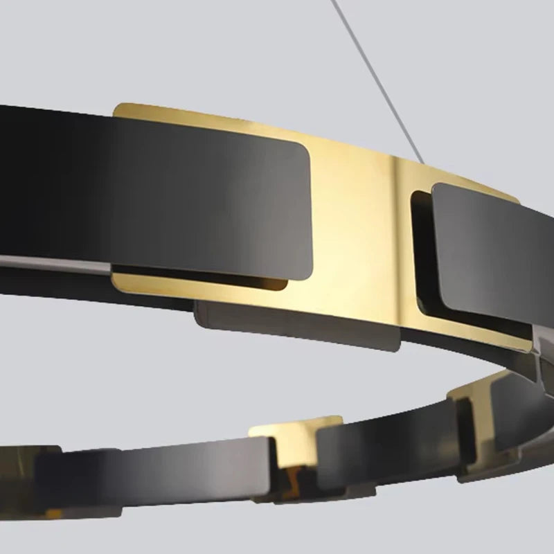 Gold and black bracelet on a light gray background