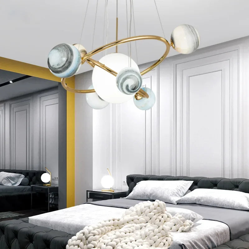 Modern chandelier in a stylish bedroom with gray walls and a bed.