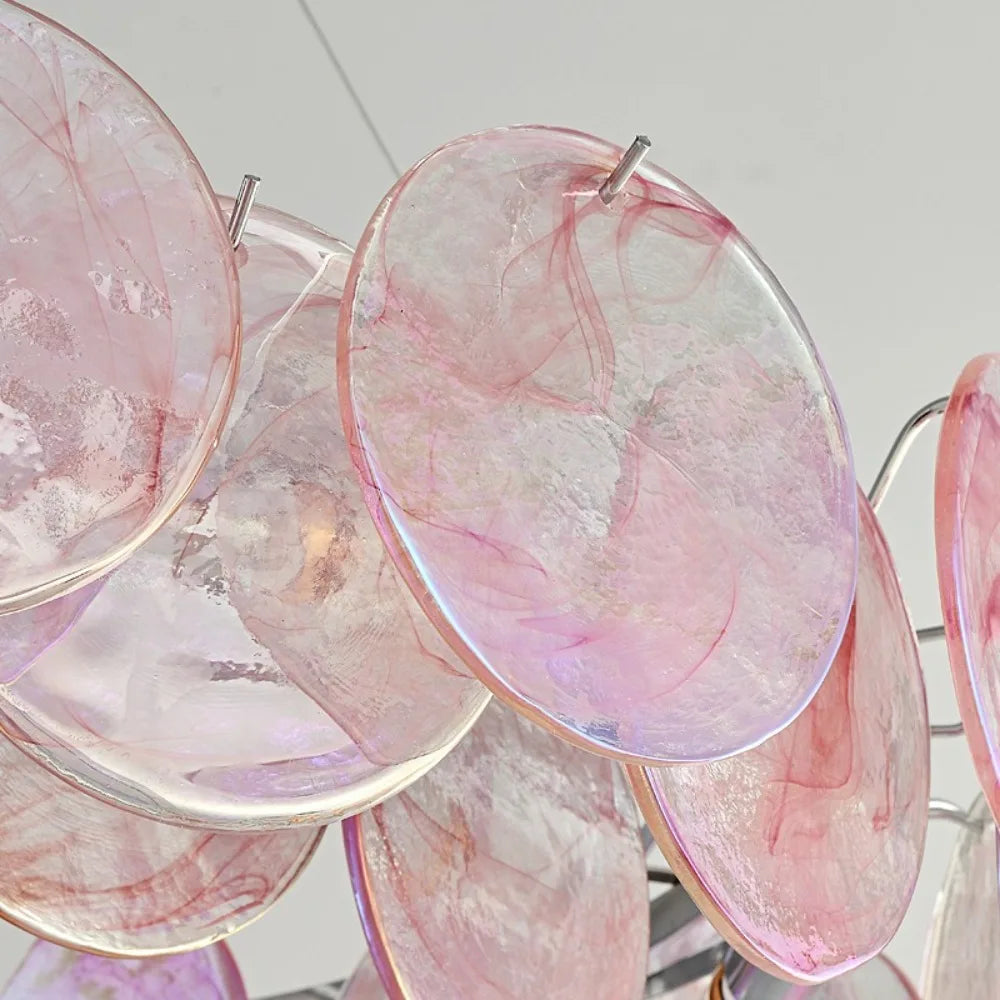 Pink and clear marbled earrings on a light gray background