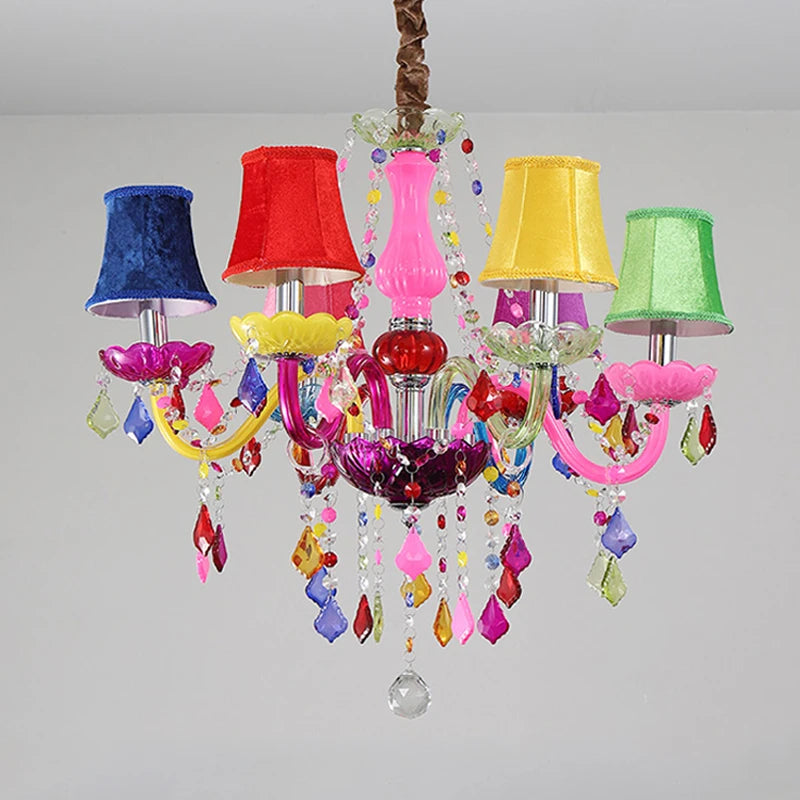 A whimsical chandelier with colorful fabric shades (blue, red, yellow, green) and cascading crystals, designed for a child's room or princess-themed decor.