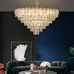 A multi-tiered crystal chandelier with a polished chrome finish illuminates a modern living room.