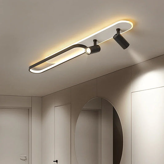 Modern black and white linear ceiling lamp with an oval accent and two adjustable spotlights mounted on a white ceiling.