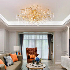 View of a gold branch crystal semi-flush mount chandelier in a living room setting.