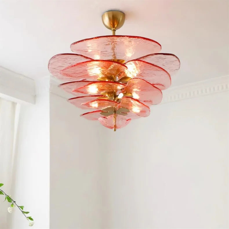 Interior scene featuring a pink glass leaf chandelier illuminating a living space.