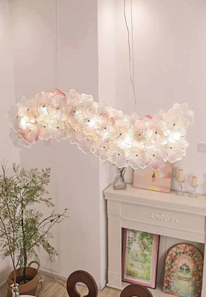 Modern chandelier hanging in a room with decor elements.