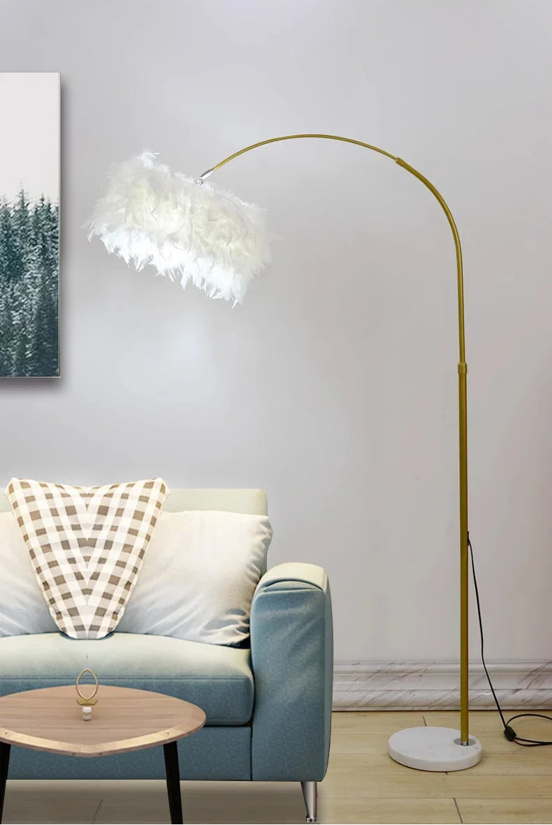 Gold floor lamp in a living room with a blue sofa and a small table.