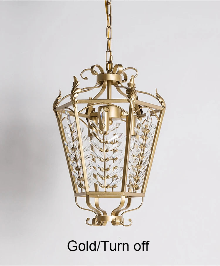 Decorative gold pendant light with clear glass on a gray background