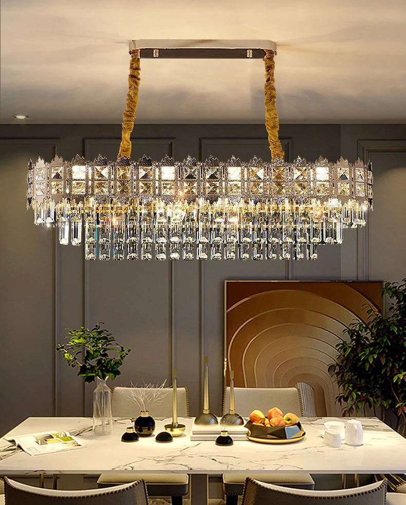 Crystal chandelier hanging above a dining table with decorative items.
