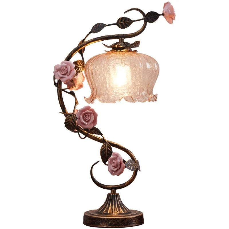 Decorative table lamp with floral design on a white background