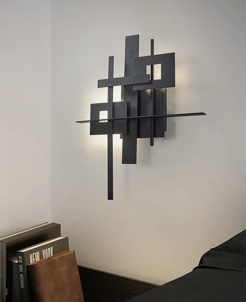 Modern wall sconce with geometric design on a neutral wall.