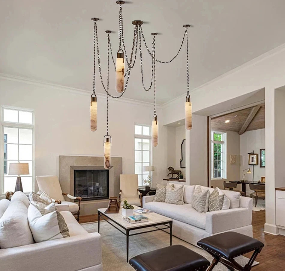 Modern living room with white sofa, coffee table, and pendant lights.