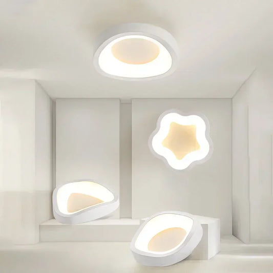 White wavy-shaped ceiling light and other modern geometric lights displayed in a white showroom