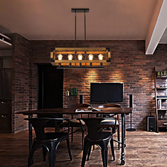 Dining room interior scene with a rectangular industrial pendant light with wood and iron accents hanging above a wooden table and chairs.