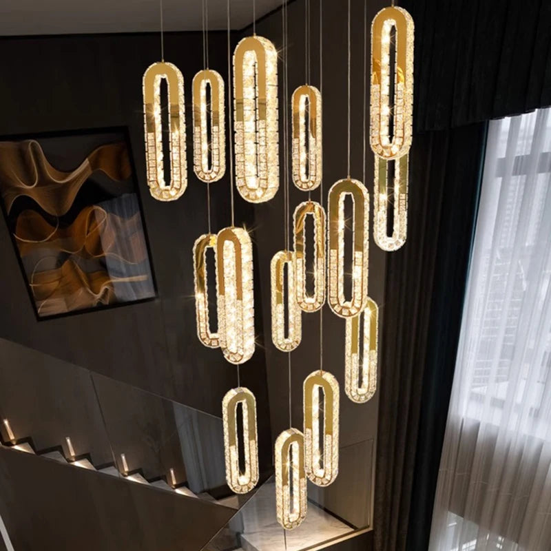 Modern chandelier hanging in a room with a dark wall and light curtain.