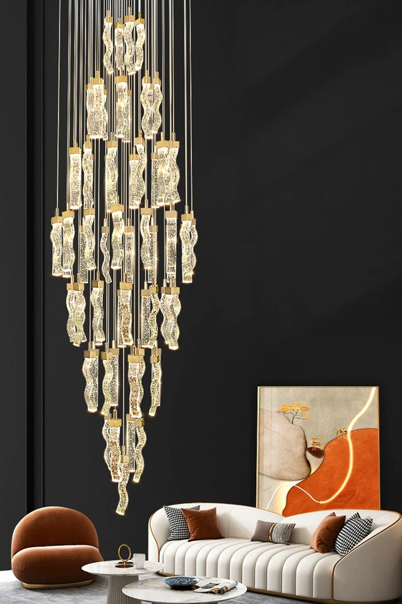 Modern chandelier hanging above a stylish living room with a sofa and artwork.